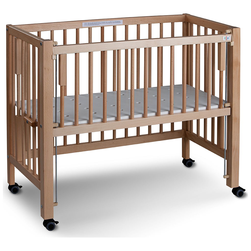 Holzbabybett mit Gitterstäben und Rollen auf weissem Hinterg